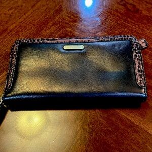 Brahmin black with brown trim wallet.  Measures 7 1/2” by 4”.